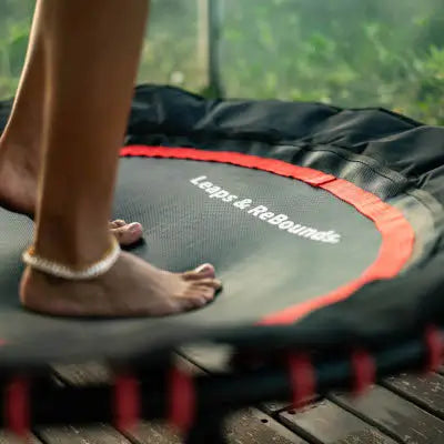 Woman bouncing pain-free on a Leaps & Rebounds rebounder