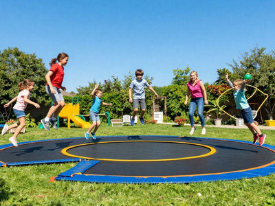 People enjoying different trampolines in a backyard