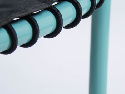 Close-up of a mini trampoline's corner with blue legs.
