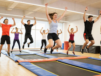 People exercising on trampolines in a fitness class.
