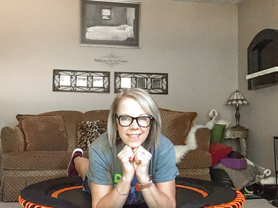 lady laying on a rebounder comfortably looking at the camera