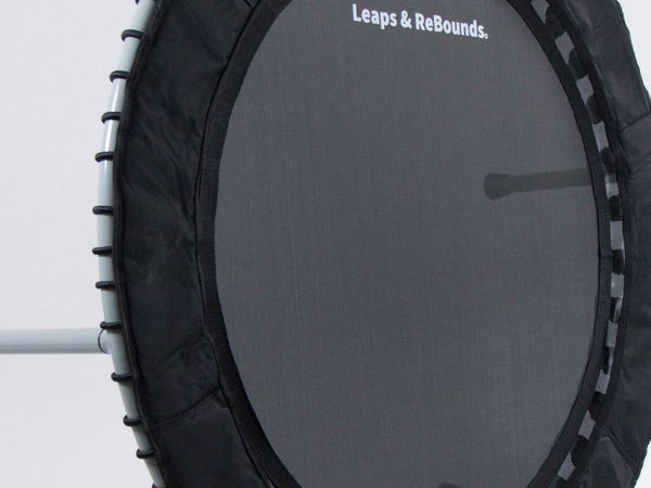 A small black exercise trampoline with three metal legs visible.