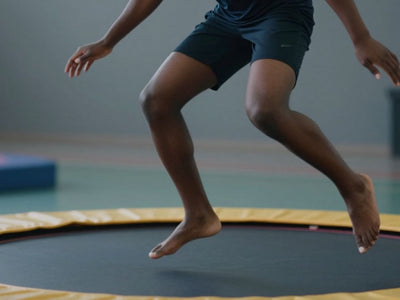 Person bouncing on a trampoline for lymphatic drainage.