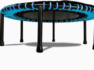 Small round trampoline with blue accents and black legs, isolated.
