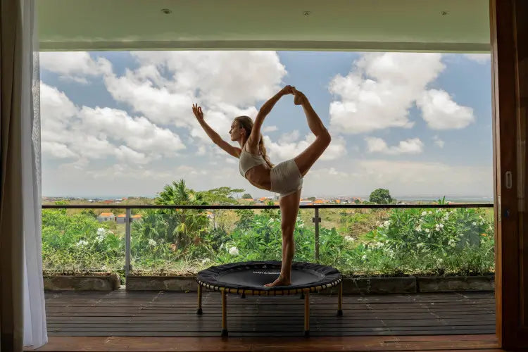 lady practicing Yoga on Leaps & Rebounds American Tough rebounder
