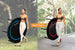 Woman is holding a small Leaps and Rebounds fitness trampoline and walking